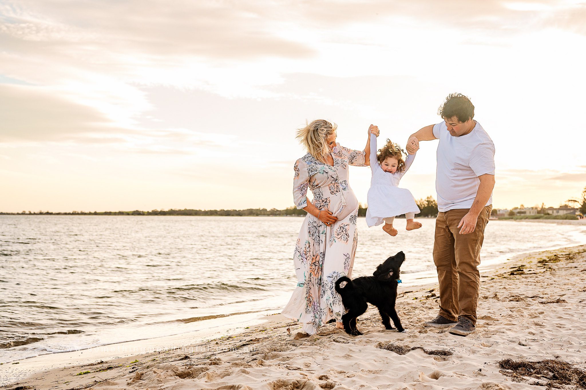 Happy family embracing nature during a maternity session in Melbourne's West with Something Meaningful