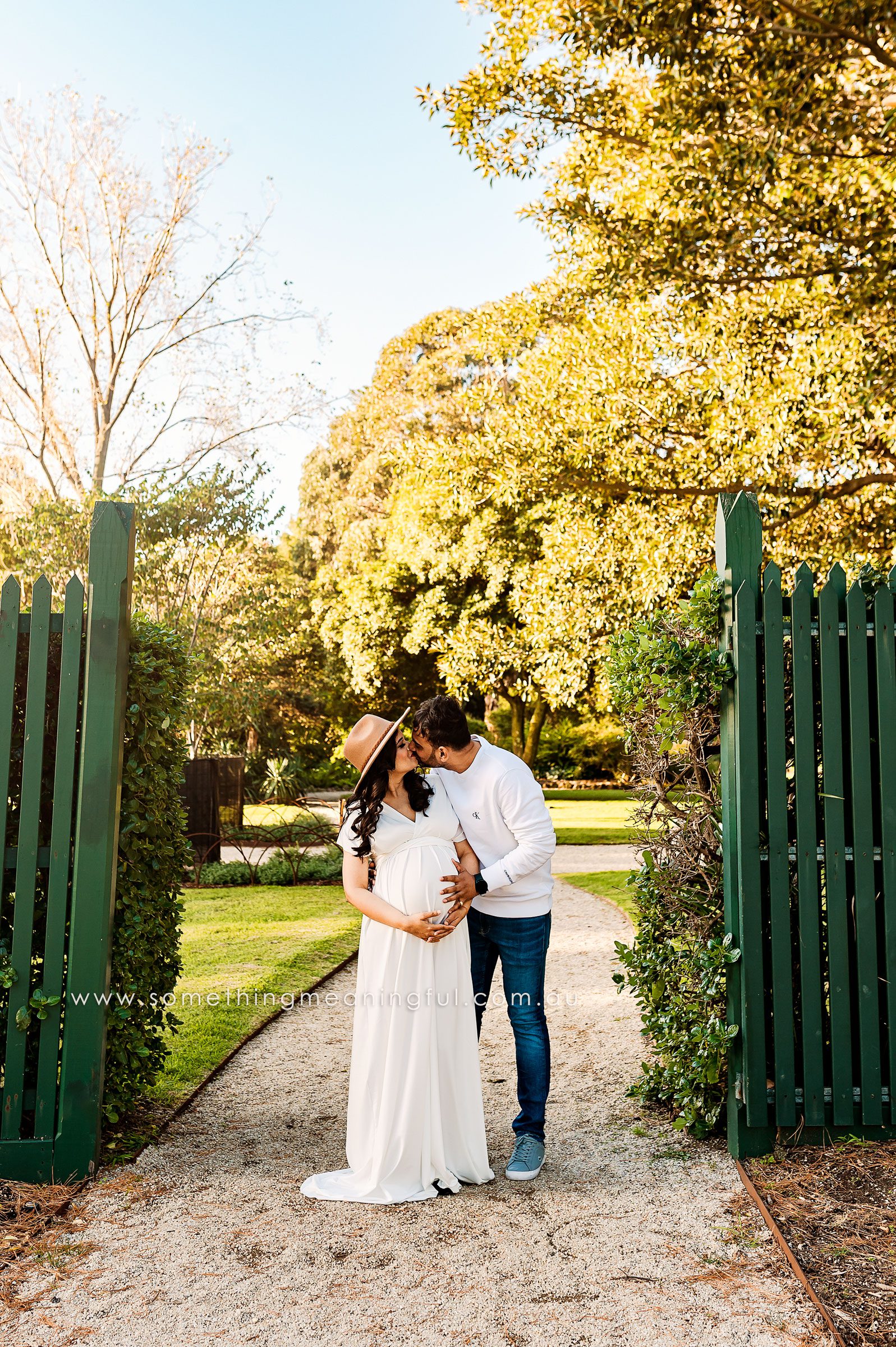 Happy expectant couple embracing, celebrating the beauty of pregnancy during a maternity photoshoot in Melbourne.